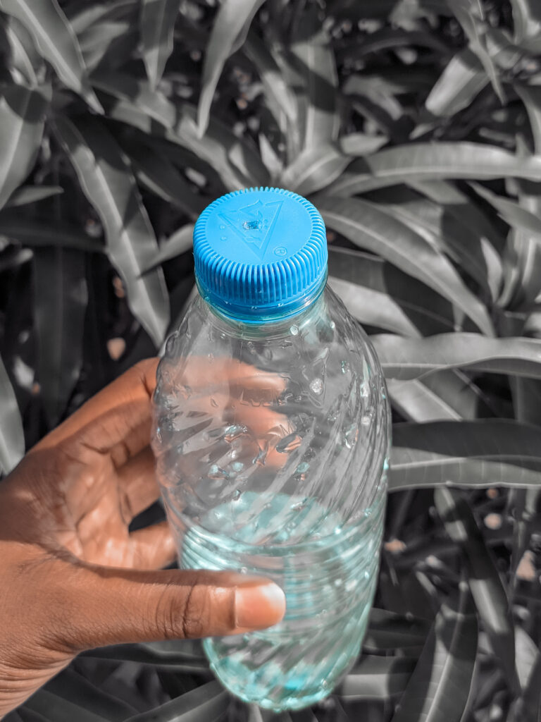 Bleach for reverse tie-dye shirt in a makeshift spray bottle